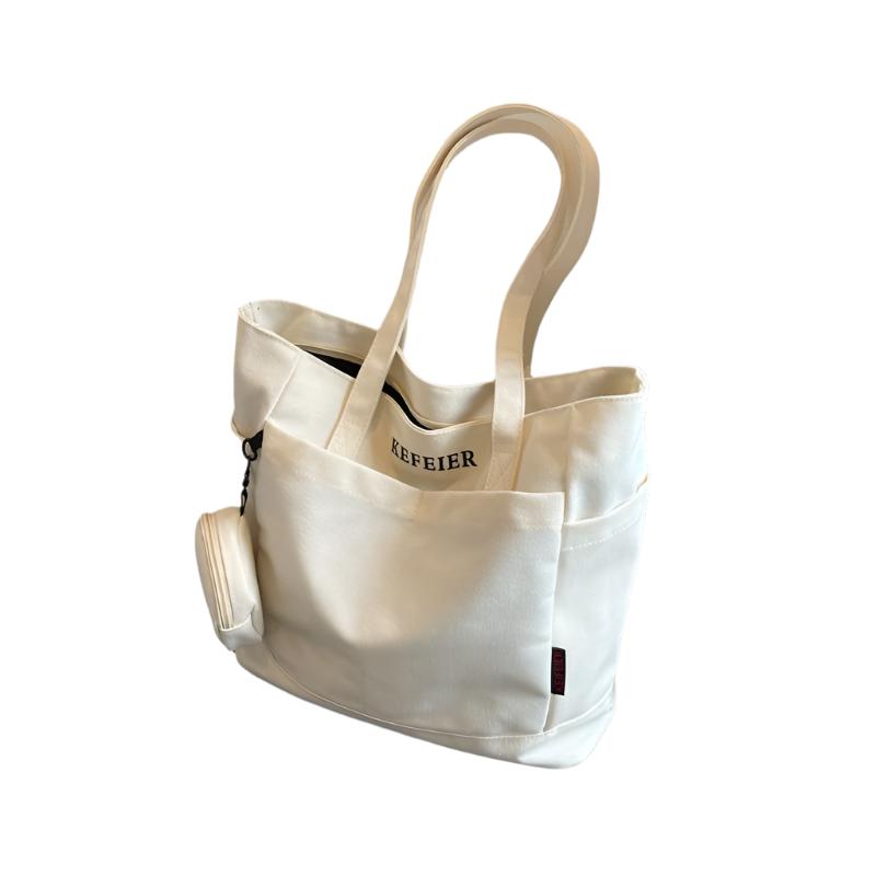 Elevate your daily commute with this Canvas Shoulder Leisure Tote Bag. Featuring a horizontal square design, it comes in black-brown, white, khaki, and army green. Made from durable canvas, the bag includes a three-dimensional pocket and a mobile phone compartment. Perfect for street trend styles and daily matching.

